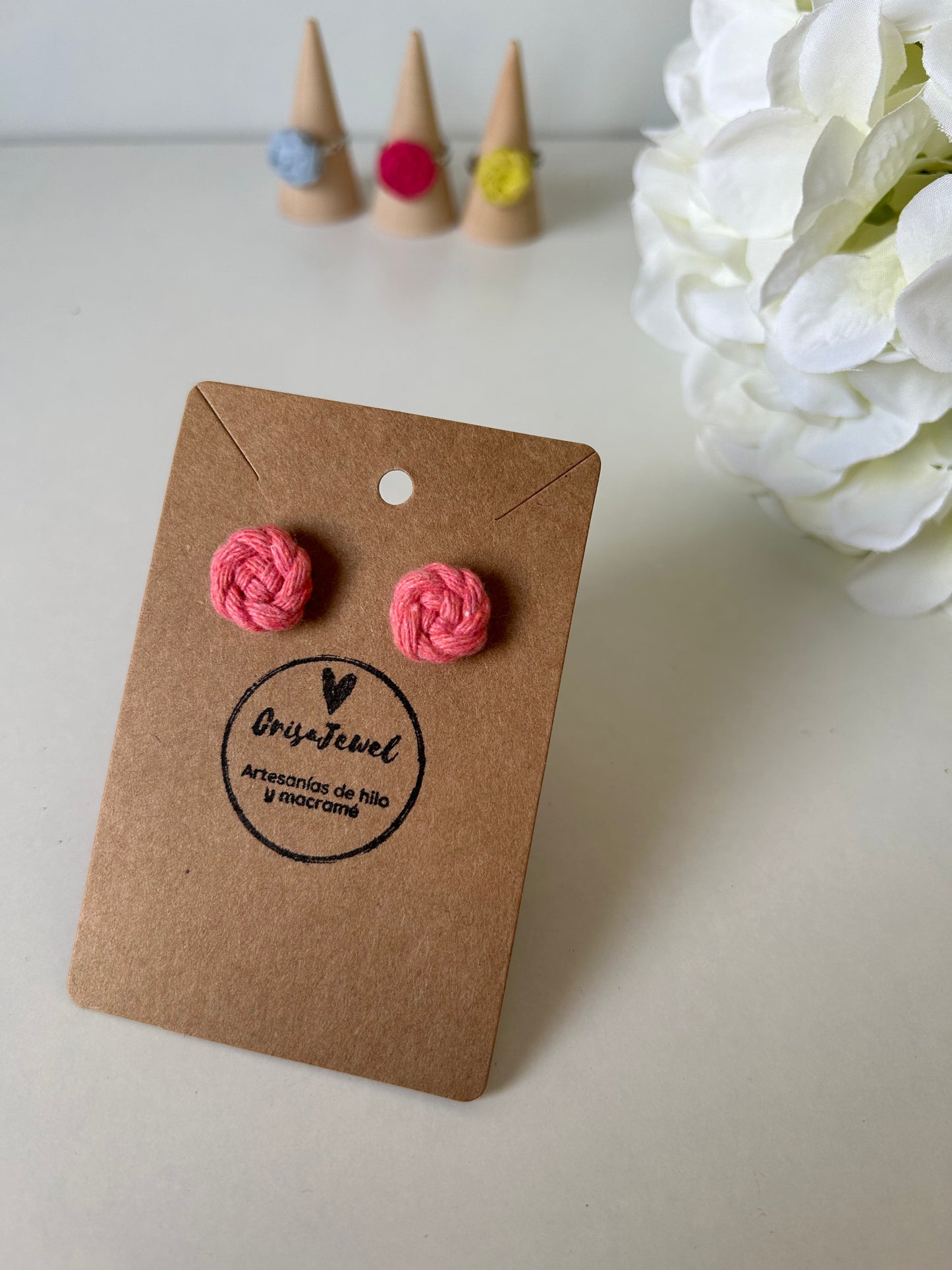 Añade un toque de creatividad a tu estilo con nuestros exclusivos pendientes Cotton de acero inoxidable, adornados con una delicada flor de algodón elaborada con la técnica de macramé. Estos pendientes combinan la sofisticación del acero con el encanto artesanal de las flores, creando una joya única y versátil.