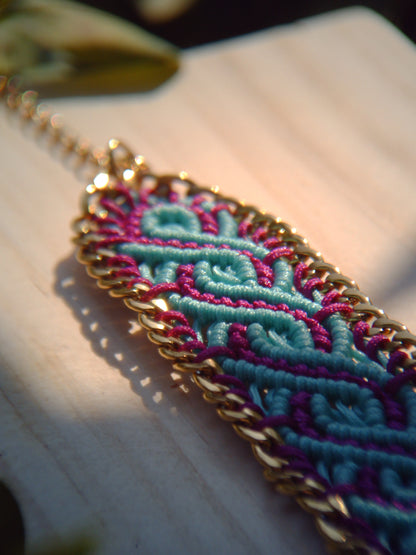 Brazalete de macramé hecho a mano con diseño geométrico, tonos vibrantes inspirados en el mar, joyería artesanal con cadena dorada